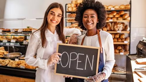 Riya — bakery owner with open sign
